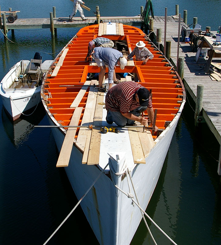 Volunteers renovating the deck